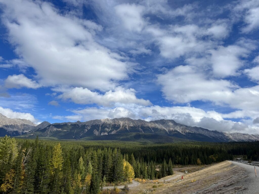 Beautiful scenic spot along Lower Kananaskis Lake shoreline with forest and mountains at the back