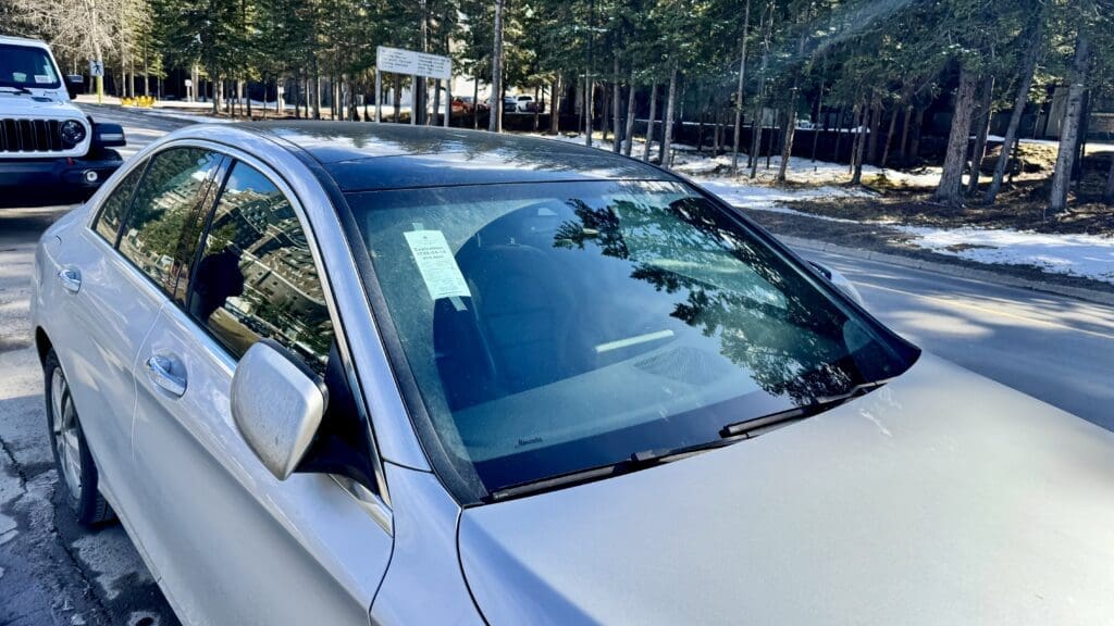 Discovery Park Day Pass is taped on the front-passenger side window